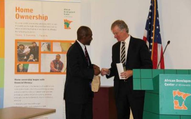African Development Center of MN executive director Nasibu Sera and Mayor Chris Coleman shake hands