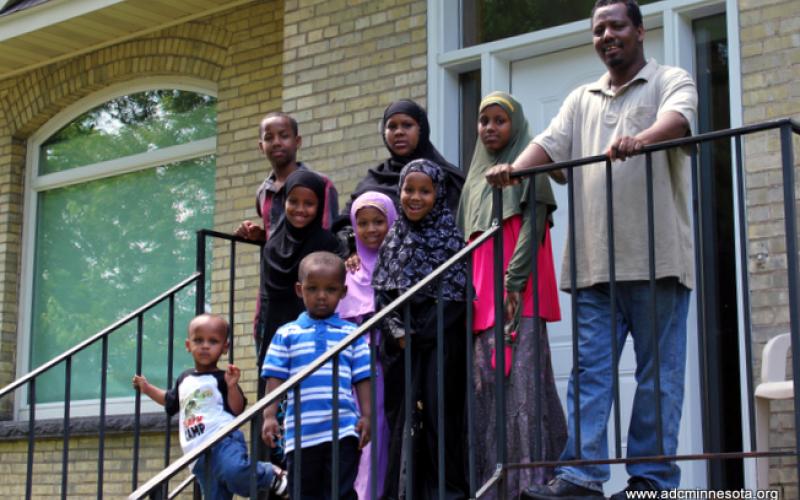 Somali family outside their newly-purchased home in St. Cloud, MN