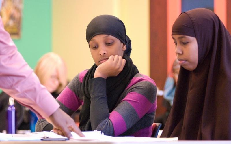 African women wearing Hijab study information about financial education